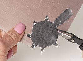 Cutting the metal piece with metal shears